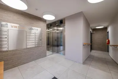 a lobby of a building with a hallway with a glass door at William's Modern Luxe Suite by the Station in Prague