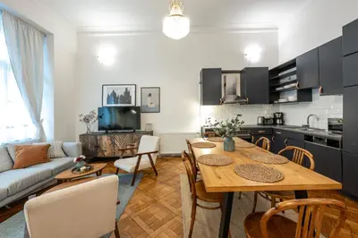 a kitchen and living room with a table and a couch at Three Bedroom Apartment near Riegrovy Sady in Prague