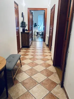 a hallway with a tiled floor in a room at Three Bedroom Apartment near Riegrovy Sady in Prague