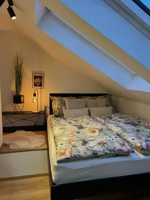 a bedroom with a bed with a floral comforter at Adel in Prague in Prague