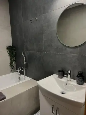 a bathroom with a sink and a mirror and a tub at Adel in Prague in Prague