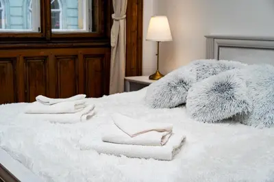 a bed with two white towels on top of it at Royal Center Palace in Prague