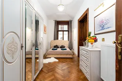 a bathroom with a mirror and a chair and a dresser at Royal Center Palace in Prague