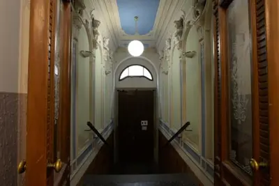 a hallway with a black door and a window at Royal Center Palace in Prague