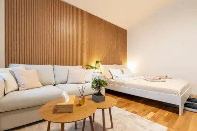 a living room with a white couch and a table at ZEN APT Prague 1 City Center Modern Studio in Prague