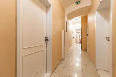 a hallway with a white door and a tile floor at ZEN APT Prague 1 City Center Modern Studio in Prague