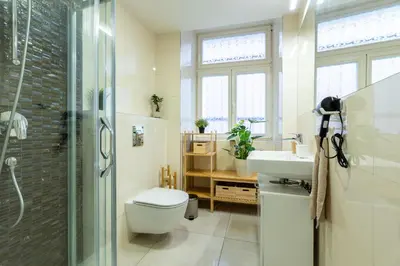 a bathroom with a shower and a toilet and a sink at ZEN APT Prague 1 City Center Modern Studio in Prague
