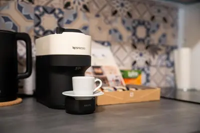 a coffee maker and a cup on a counter at ZEN APT Prague 1 City Center Modern Studio in Prague