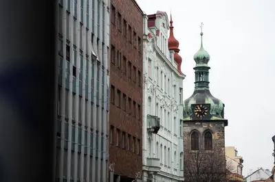 a building with a clock tower in a city at ZEN APT Prague 1 City Center Modern Studio in Prague