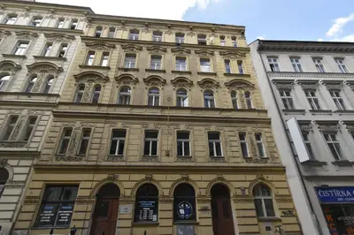 a large building with many windows on a street at Rose Essence Suite in Prague