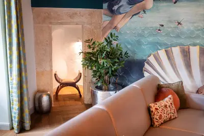 a living room with a couch and a painting at Old Royal Post Boutique Hotel & Premium Suites in Prague