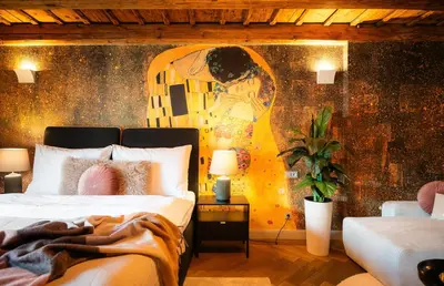 a bedroom with a bed with a painting on the wall at Old Royal Post Boutique Hotel & Premium Suites in Prague