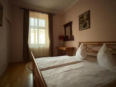 a bedroom with a large bed and a window at Vintage Charm in the Heart of Prague in Prague