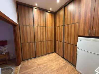 a kitchen with wooden walls and a refrigerator at Vintage Charm in the Heart of Prague in Prague