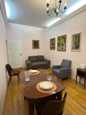 a living room with a table and a couch at Vintage Charm in the Heart of Prague in Prague
