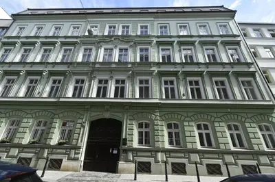 a green and white building with a black door at Vintage Charm in the Heart of Prague in Prague