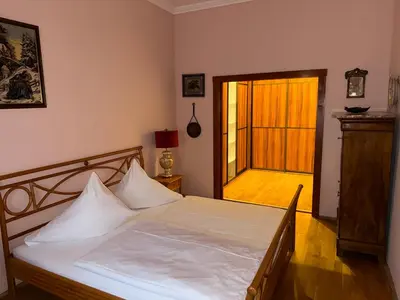 a bedroom with a bed and a door to a patio at Vintage Charm in the Heart of Prague in Prague