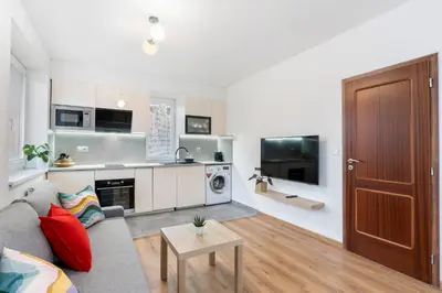 a living room with a couch and a table at The Dante House Šeberov in Prague