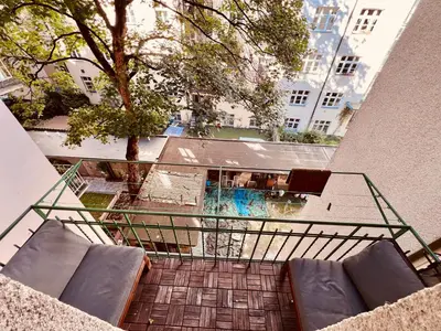 an overhead view of a balcony with chairs and a pool at Elegant & inviting entire flat on Letná in Prague