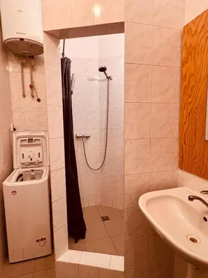 a small bathroom with a shower and a sink at Elegant & inviting entire flat on Letná in Prague