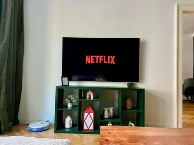 a tv sitting on top of a green shelf at Elegant & inviting entire flat on Letná in Prague