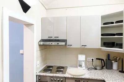 a kitchen with white cabinets and a stove top oven at Old Town - 2BR - Living Room - Sleeps 8 - Metro 1 minute - Newly renovated in Prague