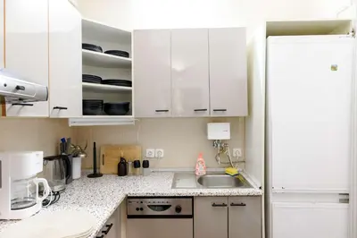 a kitchen with white cabinets and a sink at Old Town - 2BR - Living Room - Sleeps 8 - Metro 1 minute - Newly renovated in Prague