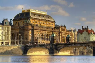 a large building with a bridge over a river at Old Town - 2BR - Living Room - Sleeps 8 - Metro 1 minute - Newly renovated in Prague