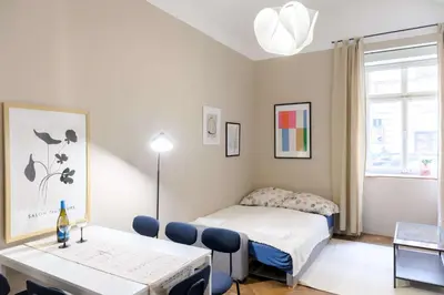 a small room with a bed and a table with a bottle on it at Old Town - 2BR - Living Room - Sleeps 8 - Metro 1 minute - Newly renovated in Prague