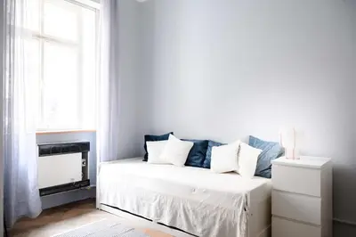 a white bed in a room with a window at Old Town - 2BR - Living Room - Sleeps 8 - Metro 1 minute - Newly renovated in Prague