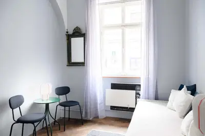 a bedroom with a bed and two chairs and a table at Old Town - 2BR - Living Room - Sleeps 8 - Metro 1 minute - Newly renovated in Prague