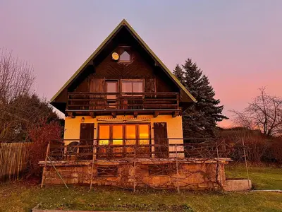 a house with a balcony on top of it at Chata v Kamenném Přívozu in Kamenný Přívoz