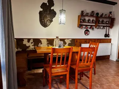 a dining room with a wooden table and chairs at Chata v Kamenném Přívozu in Kamenný Přívoz