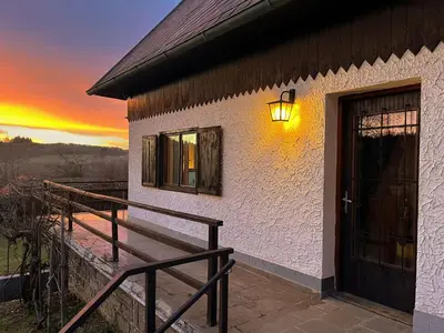 a building with a door with a sunset in the background at Chata v Kamenném Přívozu in Kamenný Přívoz
