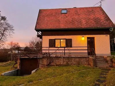 a house with a red roof on a hill at Chata v Kamenném Přívozu in Kamenný Přívoz