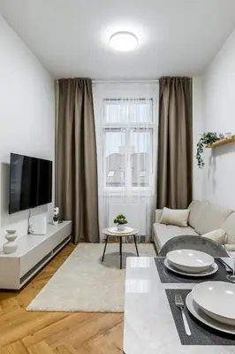 a living room with a couch and a tv at Modern apartment in the center of Prague in Prague