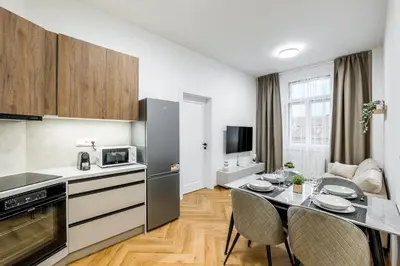a kitchen with a table and chairs in a room at Modern apartment in the center of Prague in Prague