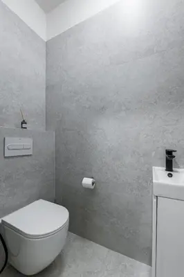 a bathroom with a white toilet and a sink at Modern apartment in the center of Prague in Prague