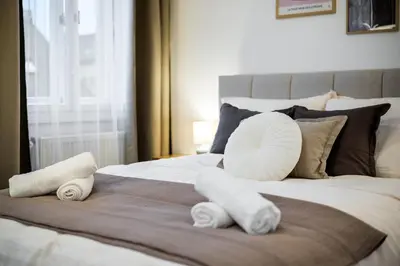 a bed with towels and pillows on it at Modern apartment in the center of Prague in Prague