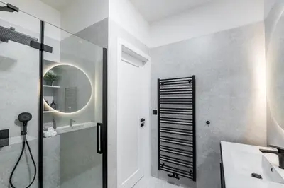a bathroom with a shower and a sink and a mirror at Modern apartment in the center of Prague in Prague