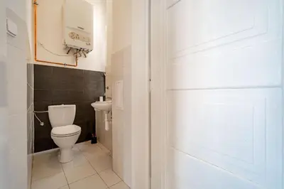 a bathroom with a toilet and a sink at Grand Old Town Suites in Prague