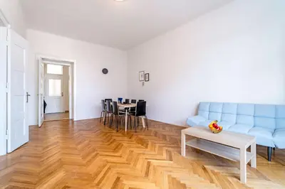 a living room with a blue couch and a table at Grand Old Town Suites in Prague