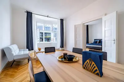 a living room with a table and chairs and a dining room at Grand Old Town Suites in Prague