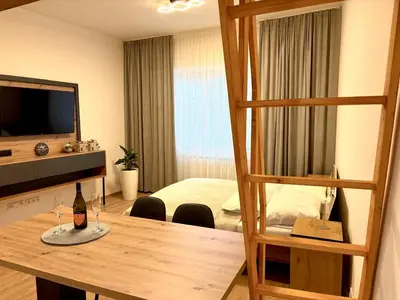 a room with a table and a room with a bedroom at Apart & Studio metro Vysočanská in Prague