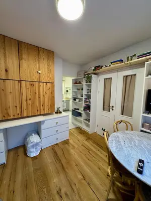 a kitchen with wooden cabinets and a table in a room at Cozy apartment with a terrace in the center of Prague in Prague