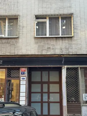 a building with two doors and a car parked in front at Cozy apartment with a terrace in the center of Prague in Prague