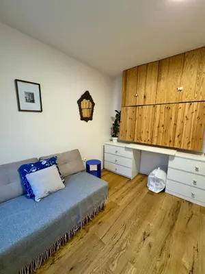 a living room with a couch and wooden floors at Cozy apartment with a terrace in the center of Prague in Prague