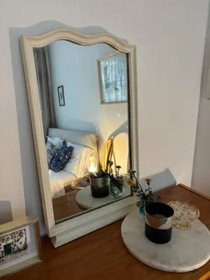 a mirror sitting on a table next to a bed at Cozy apartment with a terrace in the center of Prague in Prague