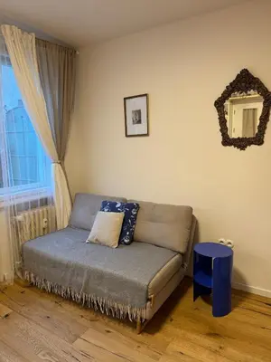 a small bed in a room with a window at Cozy apartment with a terrace in the center of Prague in Prague