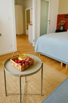 a table with a basket of fruit on it in a bedroom at HOMELY I Central 38m2 APT I ELEVATOR I Self Check-In in Prague